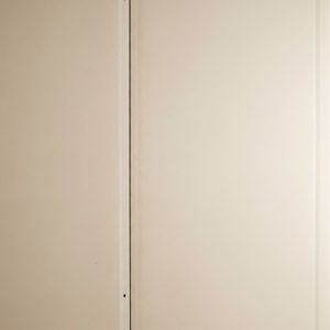 A close-up view highlights the flawless surface of a new drywall installation.